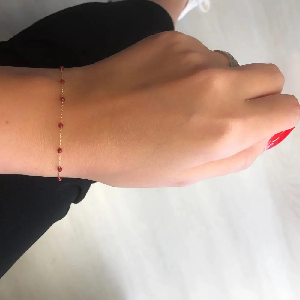 Bracelet or pierres rouges 